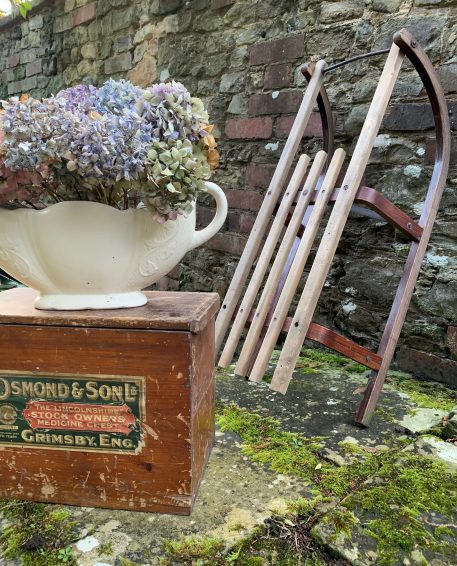 A Vintage Wooden Sleigh with Metal Edged Runners and Bar