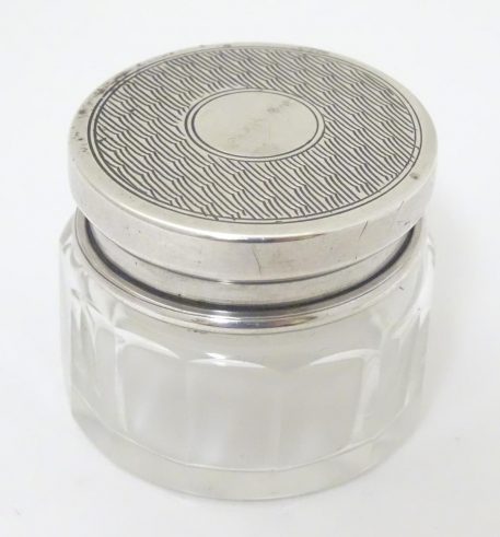 A small glass vanity jar with silver lid, hallmarked Birmingham 1927