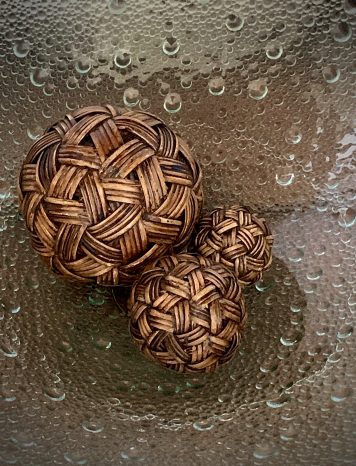 Three Decorative Wooden Orbs Shaped like Twine