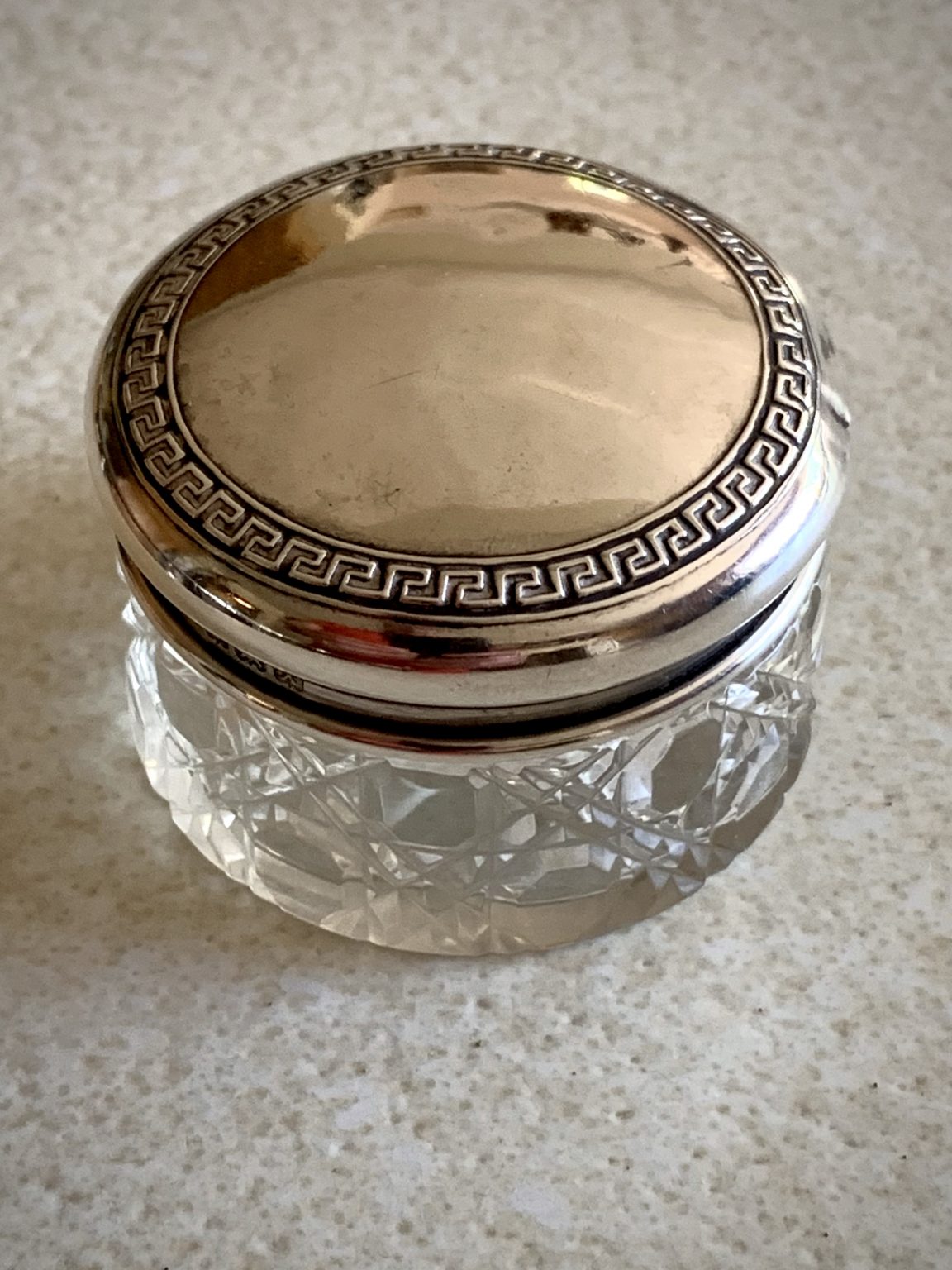 A cut glass vanity jar with silver lid, hallmarked 1922 by S ...