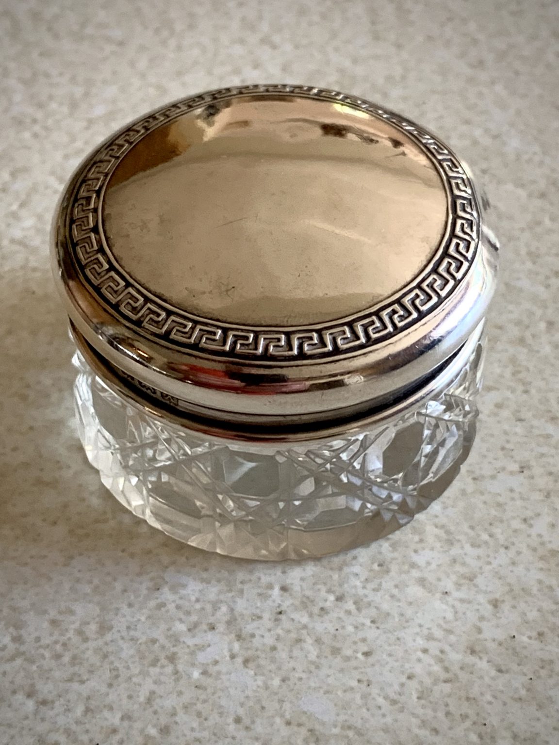A cut glass vanity jar with silver lid, hallmarked 1922 by S. Blanckensee & Son Ltd. La BelleGray