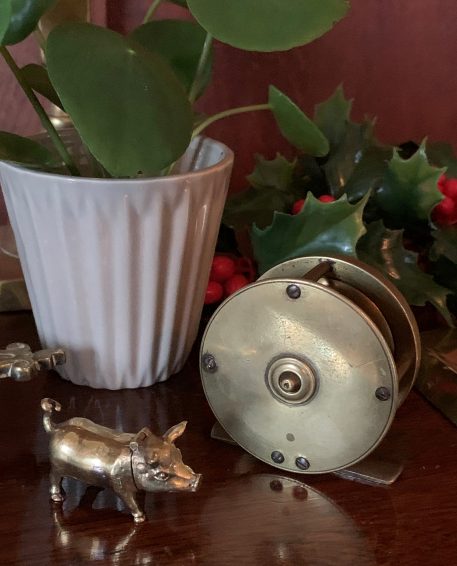 A Vintage Miniature Fishing Reel With Fixed Wooden Handle